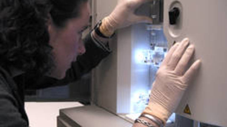 In this image provided by the National Human Genome Research Institute, a NHGRI researcher monitors a DNA sequencing machine at the NIH in Bethesda, Md. A presidential commission says new protections to ensure the privacy of people's genetic information are critical if the nation is to realize the enormous medical potential of gene-mapping.  (AP Photo/National Human Genome Research Institute, Maggie Bartlett)